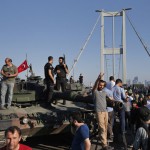 PEOPLE gather for celebration around Turkish police officers, loyal to the government, standing atop tanks abandoned by Turkish army officers, against a backdrop of Istanbul’s iconic Bosporus Bridge Saturday. (AP)