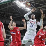 United States' Carmelo Anthony (15) fouled as he drives to the basket between Serbia's Nikola Jokic (14) and Nikola Kalinic (10) is during a men's basketball game at the 2016 Summer Olympics in Rio de Janeiro, Brazil, Friday, Aug. 12, 2016. (AP Photo/Eric Gay)