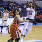 Mahindra's Joseph Eriobu shoots over Meralco's Bryan Faundo and Chris Newsome (MB Sports Photos/ Rio Leonelle Deluvio)