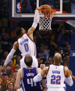 Oklahoma City Thunder guard Russell Westbrook (0) dunks in front of Sacramento Kings center Kosta Koufos (41) and teammate Taj Gibson (22) during NBA action in Oklahoma City. (AP)
