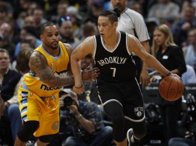 Brooklyn Nets guard Jeremy Lin, right, works the ball inside to the net as Denver Nuggets guard Jameer Nelson defends. (AP Photo/David Zalubowski)