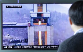 A man watches a TV news program showing an image that North Korea's Rodong Sinmun newspaper reports of a ground test of a new type of high-thrust rocket engine at Seoul Railway station in Seoul, South Korea. (AP Photo/Ahn Young-joon)