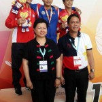 Maurice Sacho Ilustre (center) emerges as the most bemedalled Filipino tanker in the 9th ASEAN Schools Games with four golds. He copped yet another gold medal in the boys 200m butterfly Wednesday afternoon at the Singapore Sports School. (PSC PHOTO)