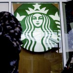 A Muslim woman walks past a Starbucks Coffee shop in Rawang outside Kuala Lumpur, Malaysia, Thursday, July 6, 2017. Muslim groups in Malaysia and Indonesia have called for a boycott of Starbucks because of the coffee chain's support for LGBT rights. (AP Photo/Daniel Chan)