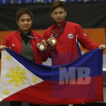 Chezka Centeno (left) and Rubilen Amit show off their medals after finishing 1-2 in the women’s 9-ball competition of the 29th SEA Games yesterday in Kuala Lumpur, Malaysia. Centeno beat Amit, 7-6 in the All-Filipino billiards final. (Ali Vicoy)