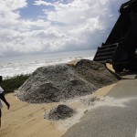 Sand is dumped along the dunes on Route A1A as protection ahead of Hurricane Irma in Flagler Beach, Fla., Friday, Sept. 8, 2017. (AP Photo/David Goldman)