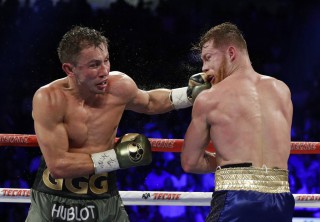 Gennady Golovkin (left) connects with a left to Canelo Alvarez during a middleweight title fight in Las Vegas. (AP)