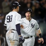 Todd Frazier #29 of the New York Yankees celebrates scoring on a wild pitch with teammate Aaron Judge #99 against the Houston Astros during the fourth inning in Game Three of the American League Championship Series at Yankee Stadium on October 16, 2017 (ELSA / GETTY IMAGES NORTH AMERICA / AFP)