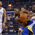 Golden State Warriors forward Kevin Durant, center, drives against Memphis Grizzlies forward James Ennis III, right, as Grizzlies center Marc Gasol (33) watches during NBA action in Memphis, Tennessee. The Grizzlies won, 111-101. (AP)