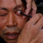 STREET barber Xiong Gaowu, 62, cleans his customer’s eye using the straight razor in Chengdu, Sichuan province, China, November 18, 2017. (Reuters)