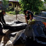 This handout photo released on December 18, 2017 by Philippine National Police Regional Office VIII (PNP-8) via their Facebook account shows rescuers carrying a body bag containing the body of a resident killed by a landslide following heavy rains triggered by Tropical Storm Kai-Tak in the town of Naval in the central Philippine province of Biliran. (Handout / PHILIPPINE NATIONAL POLICE REGIONAL OFFICE VIII / AFP)