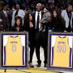 Former Los Angeles Laker Kobe Bryant poses with his family during a halftime ceremony where the LA Lakers retired his No. 8 and No. 24 jerseys. (AP)