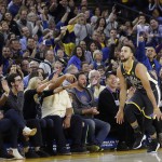 Golden State Warriors guard Stephen Curry celebrates in front of fans after scoring against the Memphis Grizzlies during NBA action in Oakland, California. (AP)