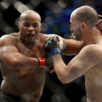 Daniel Cormier, left, exchanges blows with Volkan Oezdemir. Cormier retained the title. (AP Photo/Gregory Payan)