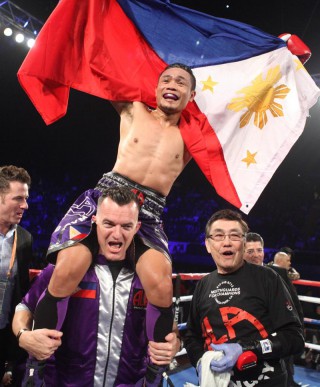 INTERNATIONAL Boxing Federation (IBF) champion Donnie Nietes hoists the Philippine flag after stopping Argentine challenger Juan Carlos Reveco in the ninth round in Inglewood, California. (Jhay Otamias)