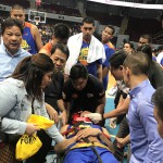 TNT KaTropa staff and medical personnel assist KaTropa forward Troy Rosario after he had a bad fall against Phoenix Fuel in the PBA Philippine Cup last Wednesday at the Mall of Asia (MOA) Arena in Pasay City. Beside the 6-foot-6 forward is wife Mich and player/agent Danny Espiritu (Waylon Galvez)