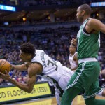 Milwaukee Bucks forward Giannis Antetokounmpo, left, falls to the floor as he is defended by Boston Celtics forward Al Horford. (AP Photo/Darren Hauck)