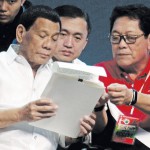 President Duterte reviews his executive order ending illegal contracting and illegal sub contracting with Special Assistant to the President Bong Go and Labor Secretary Silvestre “Bebot” Bello III at the IEC Convention Center in Cebu City. (Juan Carlo de Vela)