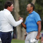 Phil Mickelson, left, and Tiger Woods shake hands after the first round of the Players Championship golf tournament. (Photo/Lynne Sladky)