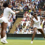 Serena Williams, left, hits a return, as her sister and playing partner Venus Williams looks on. (AP Photo/Tim Ireland, File)