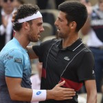 Italy's Marco Cecchinato (L) embraces as he celebrates after victory over Serbia's Novak Djokovic. (AFP PHOTO / Eric FEFERBERG)
