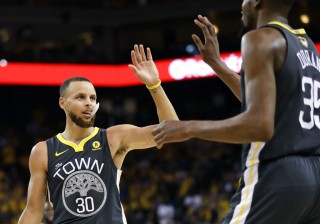 Golden State Warriors guard Stephen Curry (30) celebrates with forward Kevin Durant. AP Photo/Marcio Jose Sanchez)