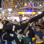 Ben Del Fante crowd-surfs as Golden State Warriors fans celebrate outside Oracle Arena in Oakland, California. The Warriors defeated the Cleveland Cavaliers 108-85 in Game 4 of the NBA Finals in Cleveland. (AP)