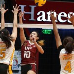 UP’s Isa Molde unleashes a hit away from UST’s Carla Sandoval’s outstretched arms as Tigress Caitlin Viray tries to provide help during their PVL Collegiate Conference showdown.