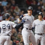 Gary Sanchez #24 and Aaron Judge #99 of the New York Yankees celebrate after Sanchez hit a three-run home run as teammate Giancarlo Stanton #27 watches during the seventh inning of Game Two of the American League Division Series against the Boston Red Sox at Fenway Park on October 6, 2018 in Boston, Massachusetts. (ELSA / GETTY IMAGES NORTH AMERICA / AFP)
