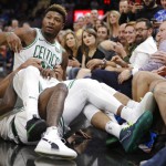 Boston Celtics' Marcus Smart is held back by teammates during a scuffle in the first half of an NBA preseason basketball game against the Cleveland Cavaliers, Saturday, Oct. 6, 2018, in Cleveland. Smart was ejected from the game. (AP Photo/Tony Dejak)