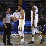 Golden State Warriors’ Stephen Curry (center) and Kevin Durant complain to referee Ben Taylor during their NBA preseason game against the Phoenix Suns Monday. The Suns won, 117-109. (AP)