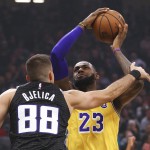 Los Angeles Lakers forward LeBron James, right, is fouled by Sacramento Kings forward Nemanja Bjelica (AP Photo/Rich Pedroncelli)