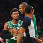 Boston Celtics guard Marcus Smart (36) is restrained by center Al Horford during the second half of the team's NBA basketball game against the Atlanta Hawks on Saturday, Jan. 19, 2019, in Atlanta. (AP Photo/Todd Kirkland)