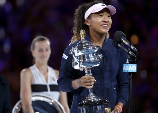 Japan's Naomi Osaka holds her trophy after defeating Petra Kvitova, left, of the Czech Republic during the women's singles final at the Australian Open tennis championships in Melbourne, Australia, Saturday, Jan. 26, 2019. (AP Photo/Mark Schiefelbein)