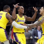 LOS Angeles Lakers guard Rajon Rondo, middle, celebrates his game-winning shot with teammates LeBron James (23) and Kyle Kuzma (0) during their game against the Boston Celtics in Boston. The Lakers won 129-128. (AP)