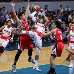Phoenix forward Calvin Abueva makes an off-balance shot against Alaska’s Carl Bryan Cruz and Chris Banchero during their PBA Philippine Cup game Friday at the Mall of Asia Arena in Pasay City. Abueva tallied 21 points and 16 boards to help the Fuel Masters beat the Aces, 94-80. (PBA images)