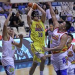 Troy Rosario of TnT KaTropa puts up a shot against Beau Belga of Rain or Shine. (PBA Images)
