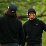 Tiger Woods (R) of the United States smiles with Pat Perez (L) of the United States on the practice green (Mike Ehrmann / GETTY IMAGES NORTH AMERICA / AFP)