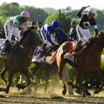 Jockey Joel Rosario, atop Sir Winston (7), right, reacts as after crossing the finish line ahead of Tacitus (10), with jockey Jose Ortiz up, to win the 151st running of the Belmont Stakes horse race, Saturday, June 8, 2019, in Elmont, N.Y. (AP Photo/Steven Ryan)