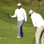 Tiger Woods, left, putting on the 4th green at Royal Portrush Golf Club, Northern Ireland during a practice round ahead of the148th Open Golf Championship from 18-21 July 2019. (AP Photo/Peter Morrison)